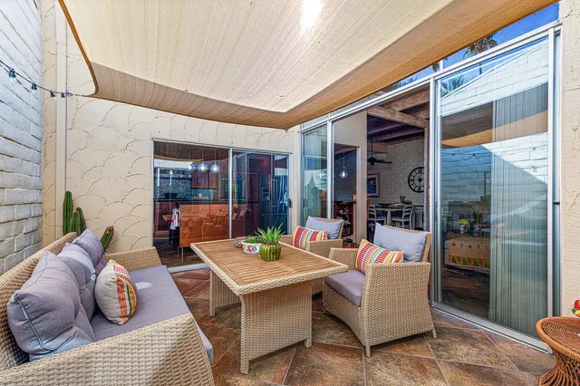 a living room with furniture rug and lamp