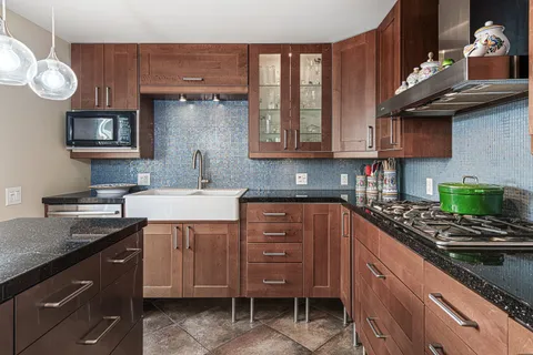 a kitchen with cabinets appliances and a counter top space