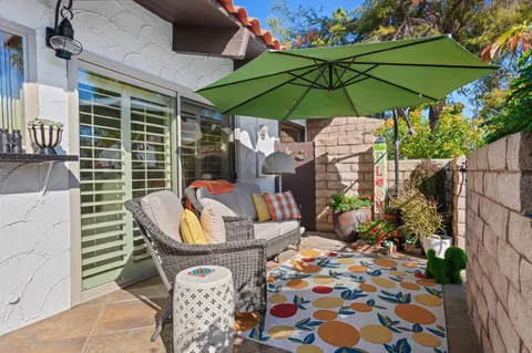 an outdoor space with furniture and umbrella