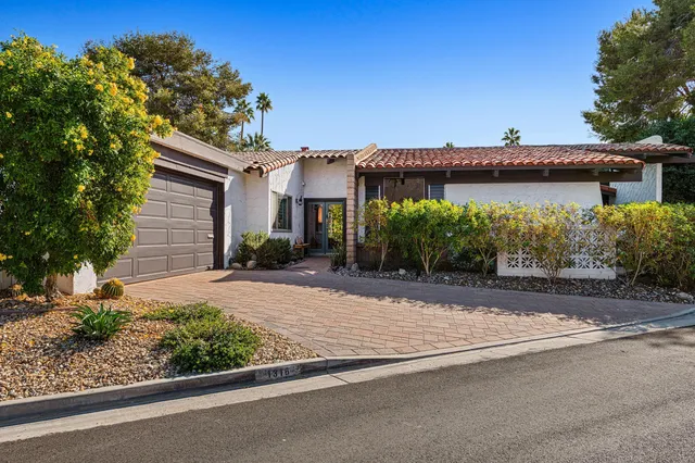 a front view of a house with a yard and a garage