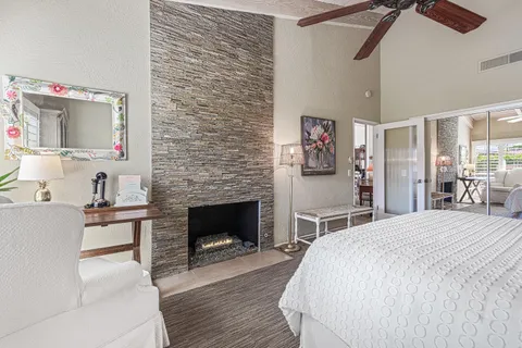 a spacious bedroom with a bed and a fireplace