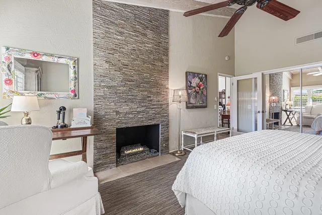 a spacious bedroom with a bed and a fireplace