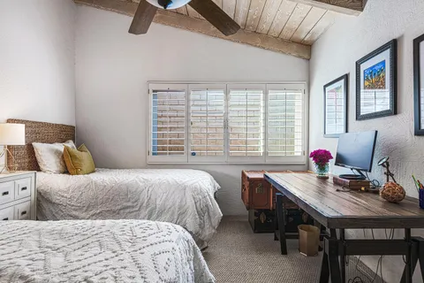 a bedroom with a bed and a night stand