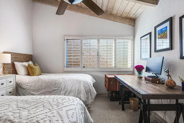 a bedroom with a bed and a night stand