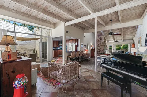 a living room with furniture a rug and a chandelier