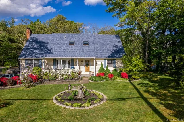 a front view of a house with a yard fountain and a fountain
