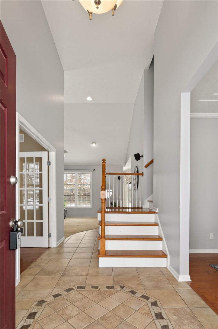 133 Blue Aspen Way Greece, NY 14612 - Photo 4 of 35 A graceful side staircase overlooks the family roo