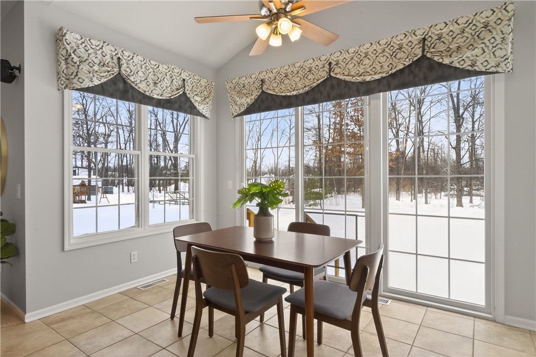 133 Blue Aspen Way Greece, NY 14612 - Photo 10 of 35 Morning Room with wall of windows that faces woode