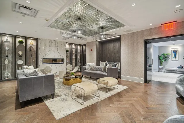 a living room with furniture and a chandelier