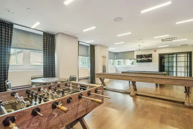 a large kitchen with a table and chairs in it