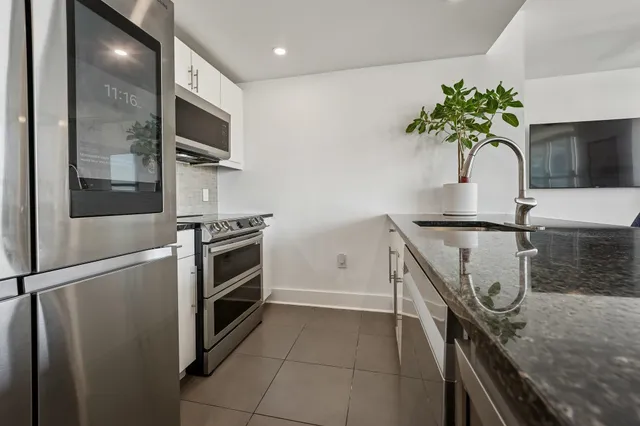 a kitchen with stainless steel appliances a refrigerator and a sink