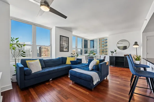 a living room with furniture and wooden floor