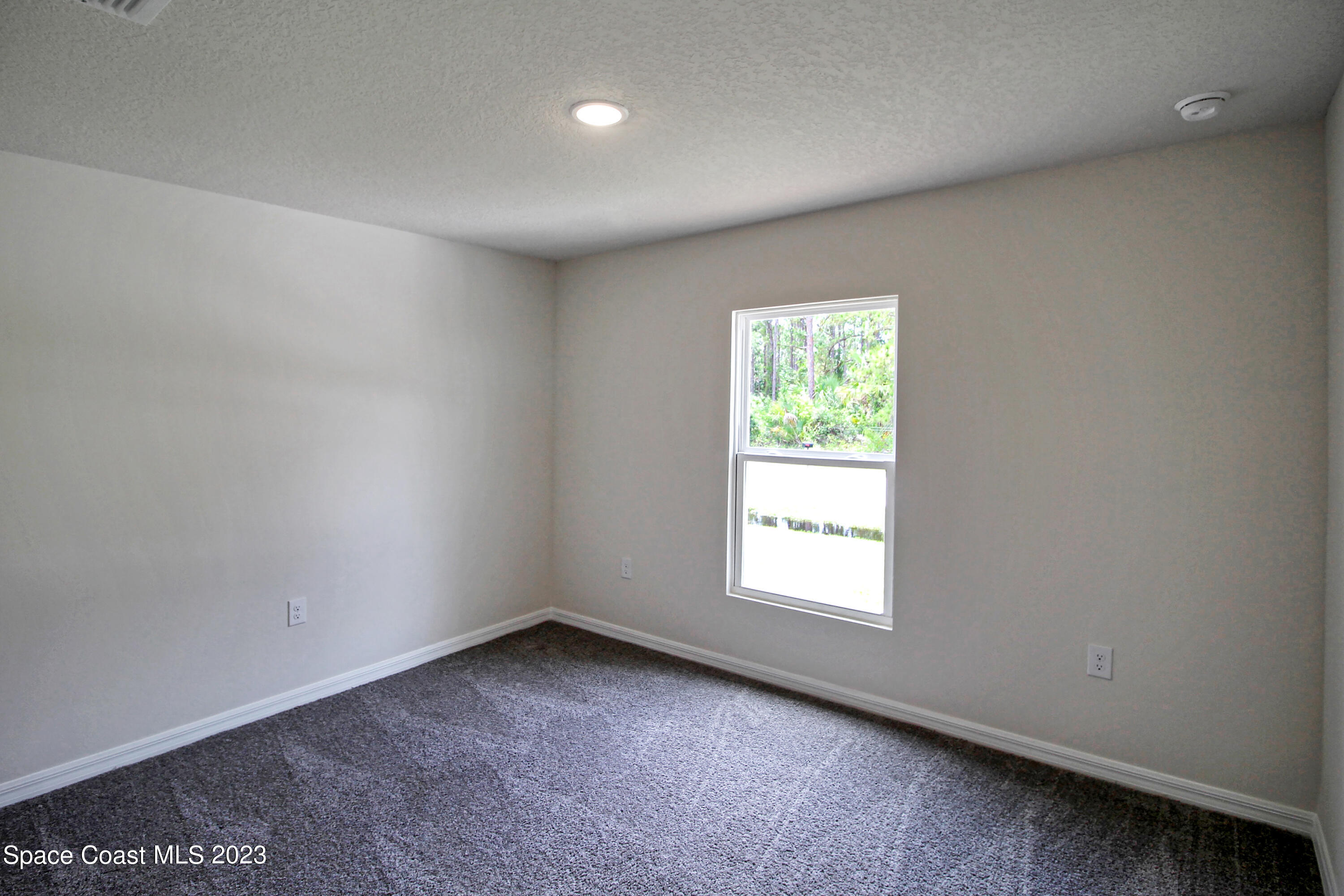 751 Schean Avenue Southwest Palm Bay, FL 32908 - Photo 12 of 12 an empty room with windows