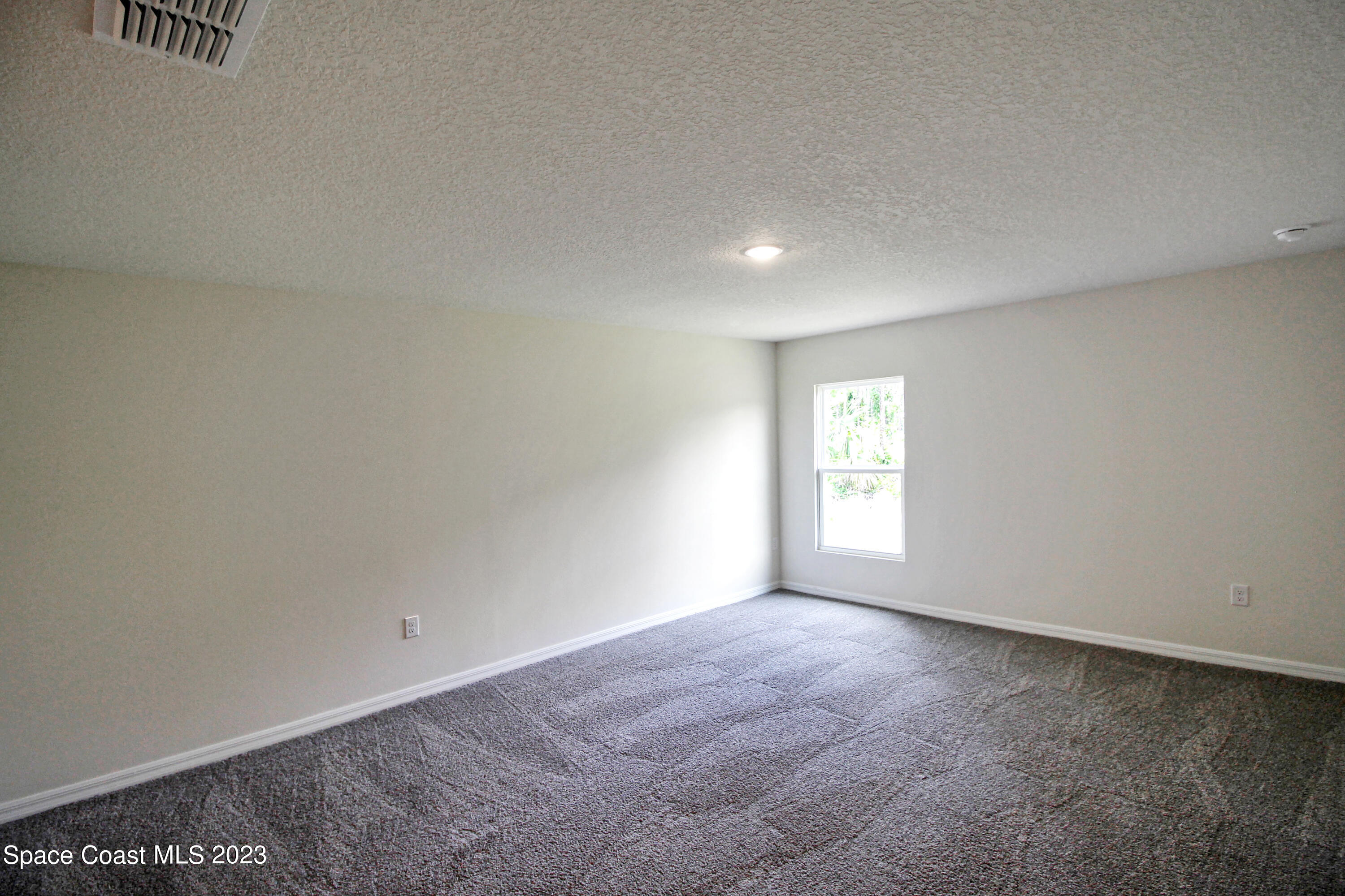 751 Schean Avenue Southwest Palm Bay, FL 32908 - Photo 10 of 12 an empty room with windows