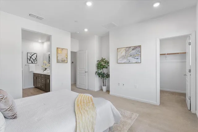 a bedroom with a bed and painting on the wall