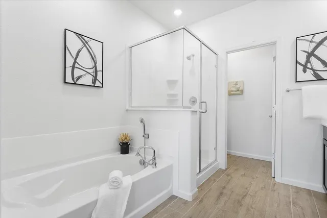 a bathroom with a bathtub and a shower