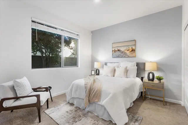 a bedroom with a bed and glass window