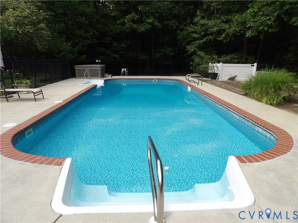 7106 Swiftrock Ridge Place Chesterfield, VA 23838 - Photo 3 of 4 Rectangular inground pool featuring integrated ste