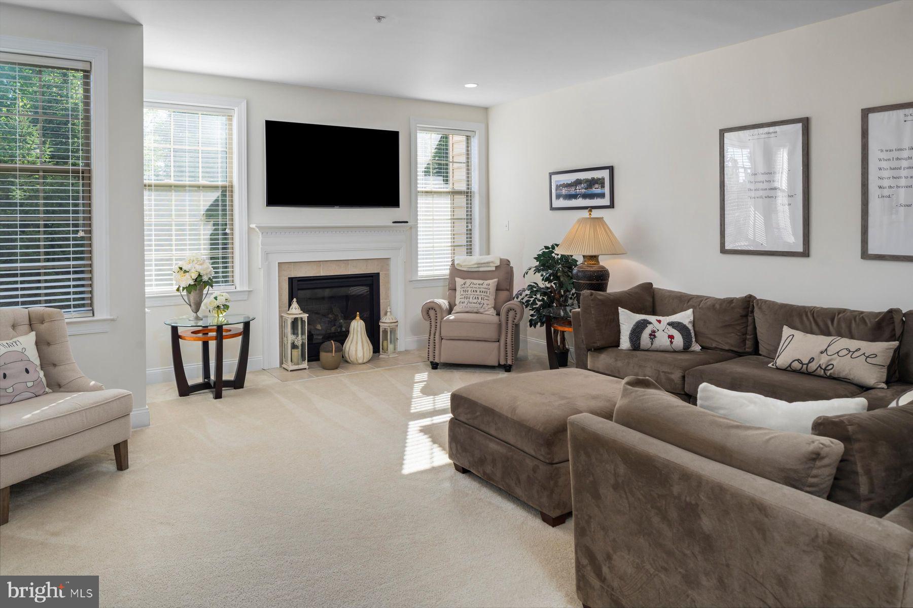 91 Lilac Road Malvern, PA 19355 - Photo 11 of 34 a living room with furniture a fireplace and a flat screen tv