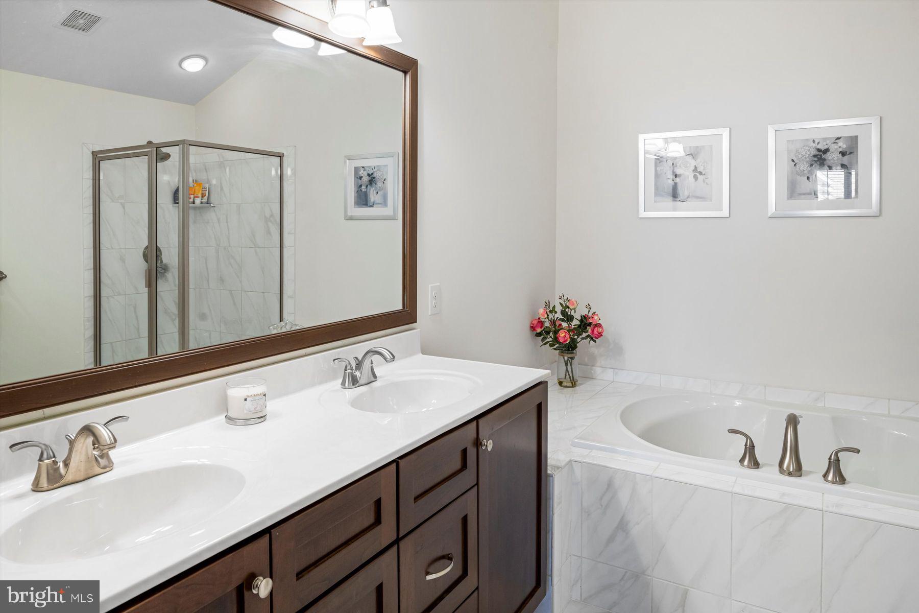 91 Lilac Road Malvern, PA 19355 - Photo 18 of 34 a bathroom with a tub sink and mirror