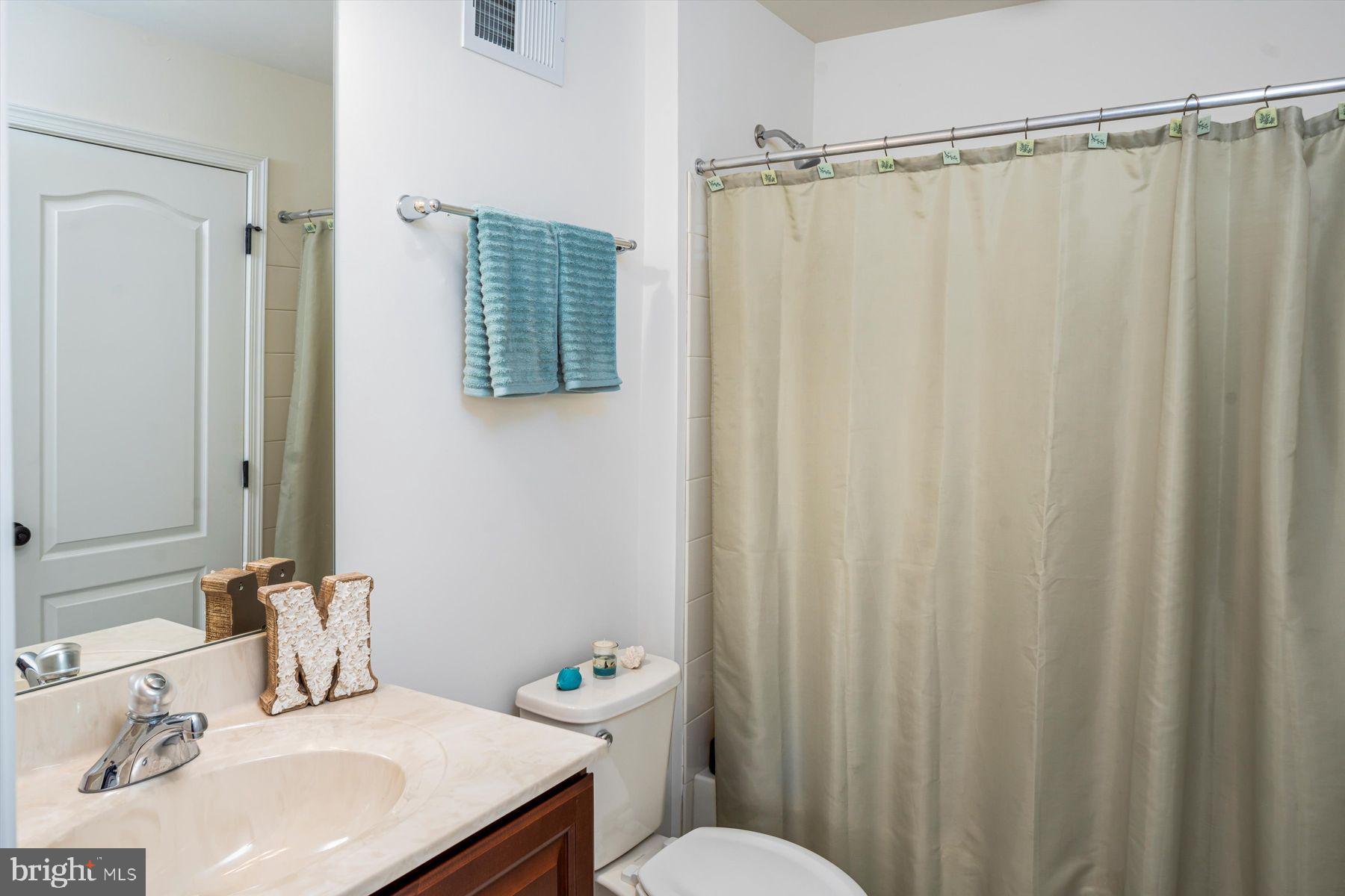 91 Lilac Road Malvern, PA 19355 - Photo 21 of 34 a bathroom with a sink a toilet and shower curtain