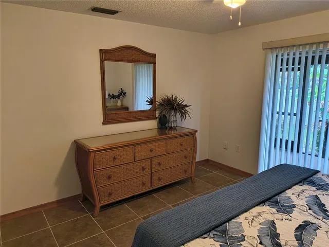 a bedroom with a bed and a dresser in it
