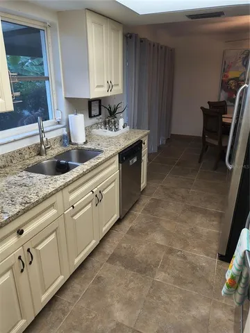 a kitchen with sink cabinets and window