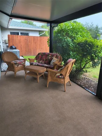 a view of a patio with a table and chairs