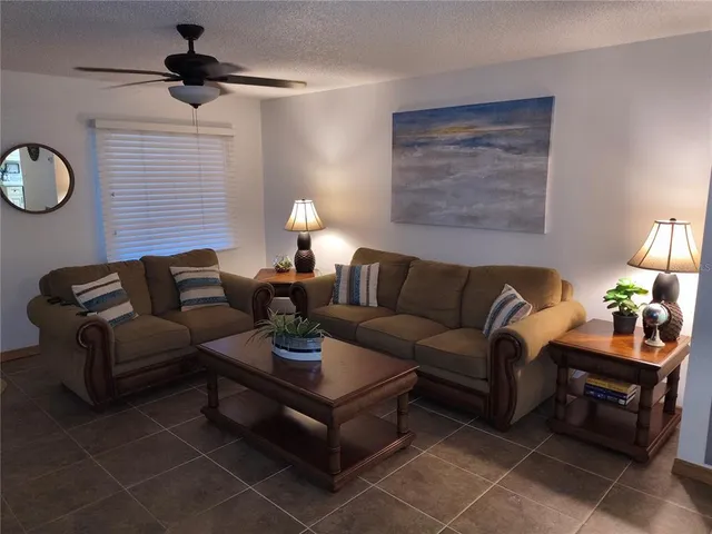 a living room with furniture and a lamp