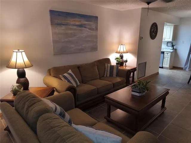 a living room with furniture and a lamp