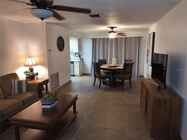 a dining room with furniture and wooden floor