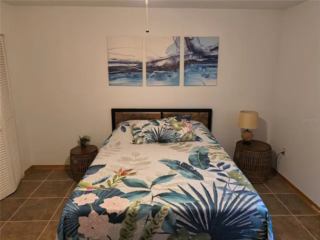 a bedroom with a bed and ceiling fan