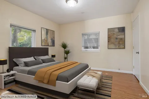 an empty room with wooden floor and window