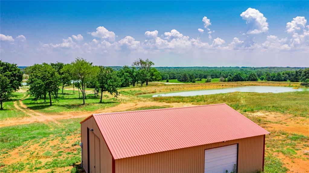 1789 Brumelow Road Whitesboro, TX 76273 - Photo 19 of 30 Metal outbuilding with a red pitched roof and white garage door