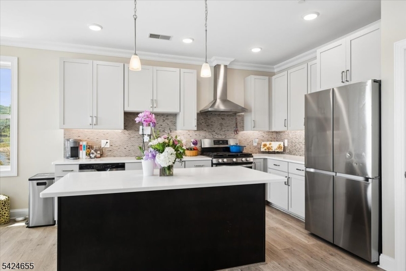 401 Mariners Pointe Hopatcong, NJ 07843 - Photo 13 of 42 a kitchen with kitchen island white cabinets and stainless steel appliances