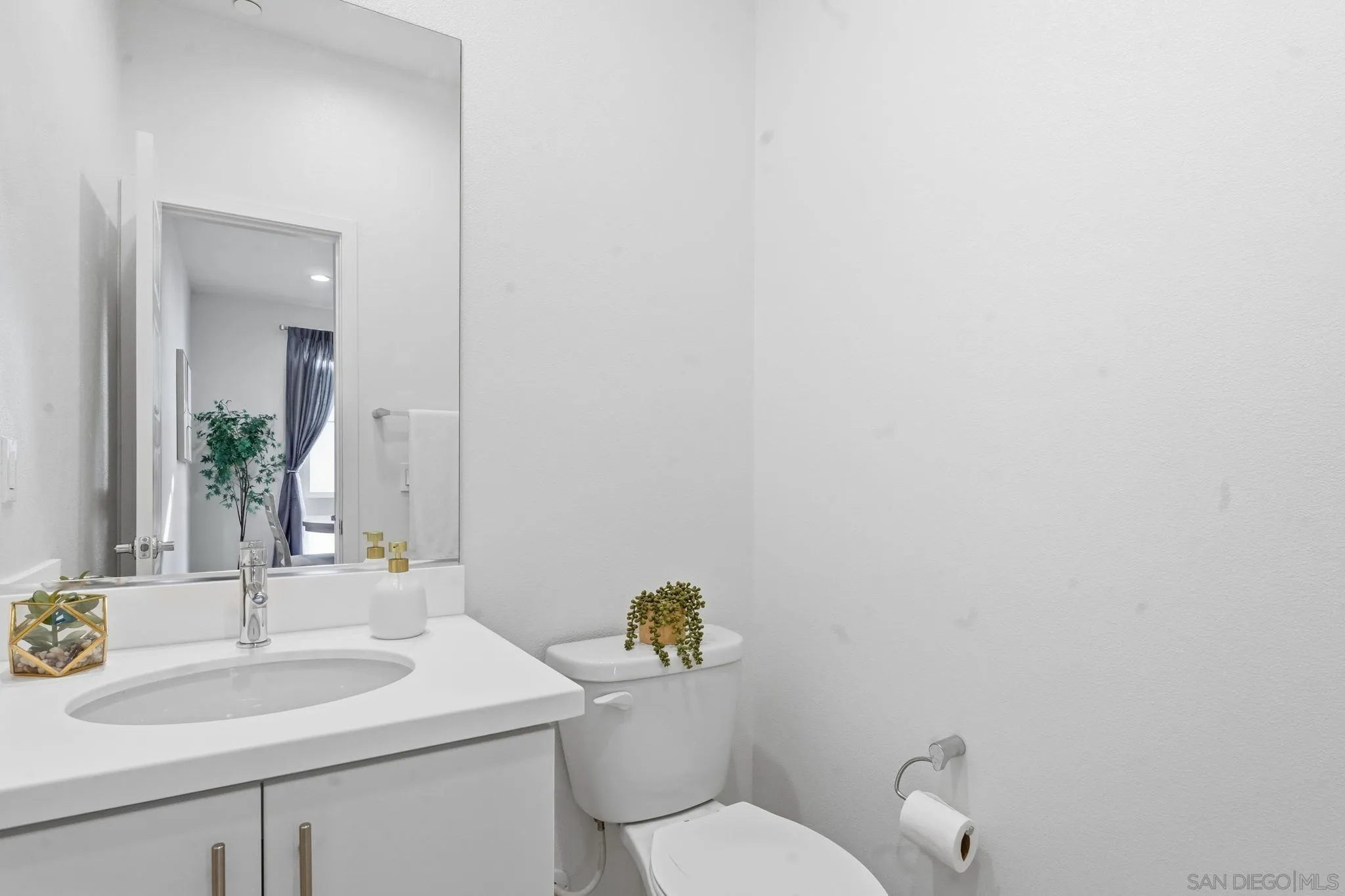 2275 Element Way, Unit 4 Chula Vista, CA 91915 - Photo 33 of 45 a bathroom with a toilet sink and mirror