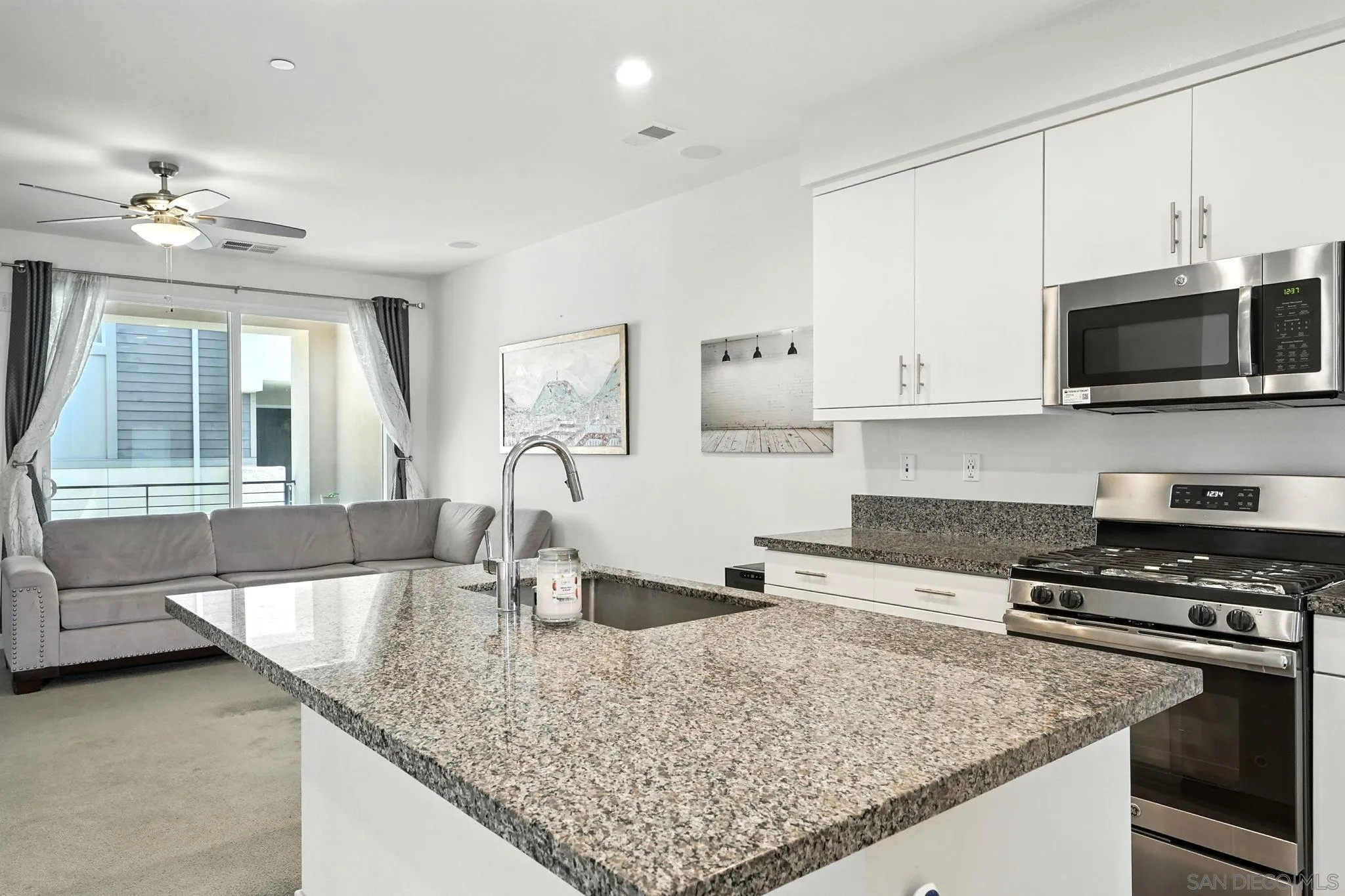 2275 Element Way, Unit 4 Chula Vista, CA 91915 - Photo 7 of 45 a kitchen with stainless steel appliances granite countertop a sink stove and microwave