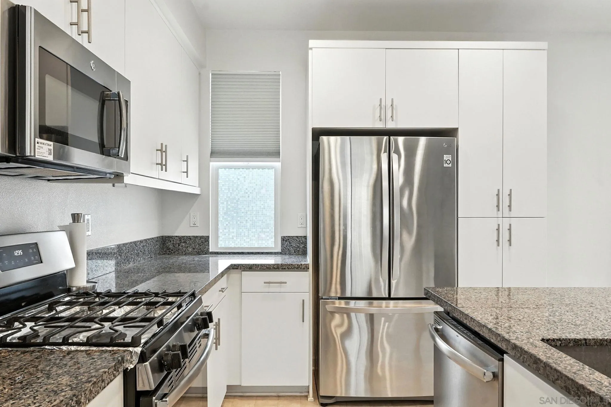 2275 Element Way, Unit 4 Chula Vista, CA 91915 - Photo 10 of 45 a kitchen with stainless steel appliances granite countertop a refrigerator stove and sink
