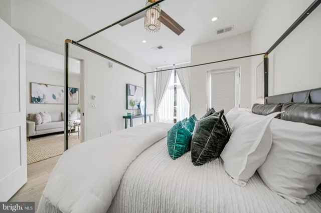 a bedroom with a bed and wooden floor