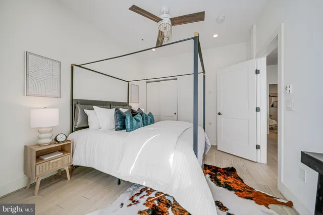 a bedroom with a bed and a potted plant