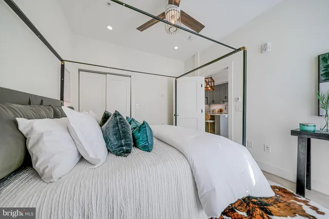 a living room with furniture and kitchen view