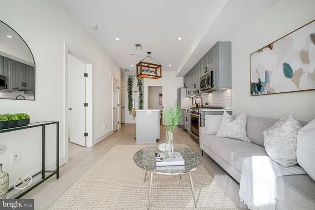 a bathroom with a tub shower vanity and a sink