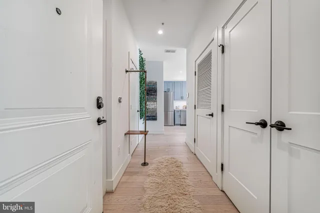 a view of a rooftop deck with couch and chairs