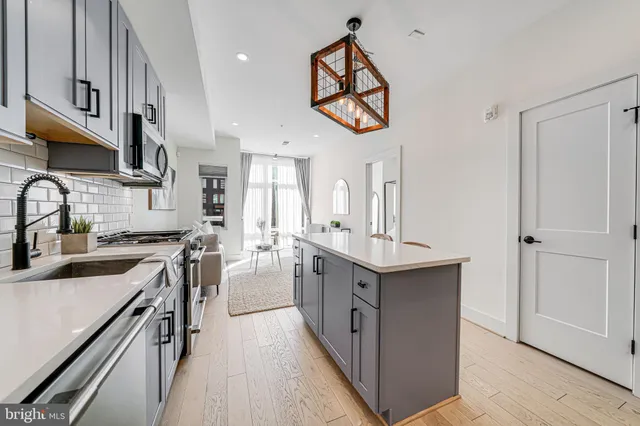 a large bed sitting in a bedroom next to a window