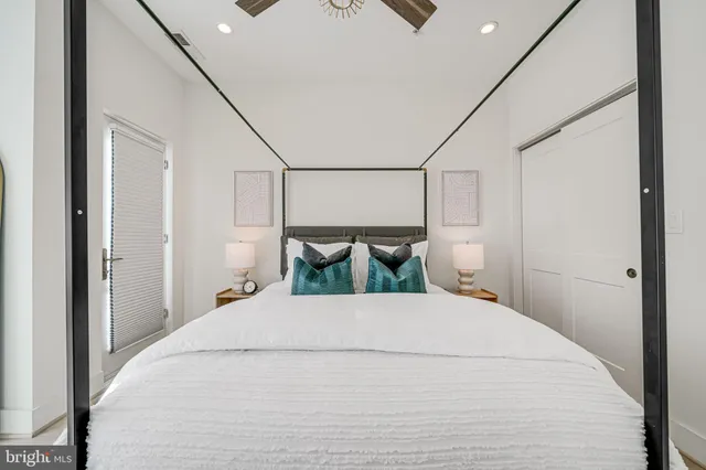 a bedroom with a bed window and table