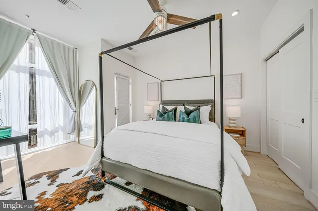 a bedroom with a bed and a large mirror