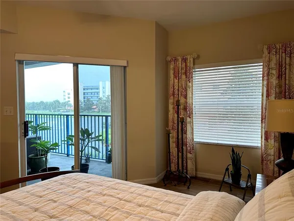 a bedroom with a large window and a bed