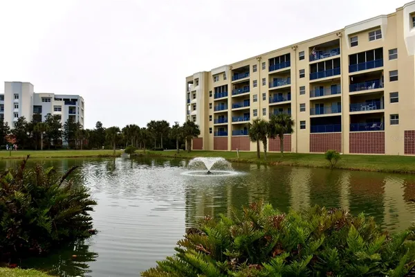 a view of building with river in front of it