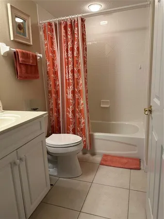 a bathroom with a toilet a sink and a shower