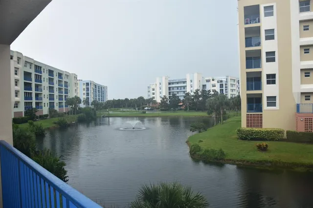 a view of a lake with a building and outdoor space